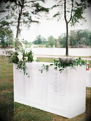 White bar front covered with greenery