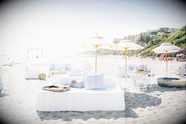 White lounge furniture and umbrellas on beach