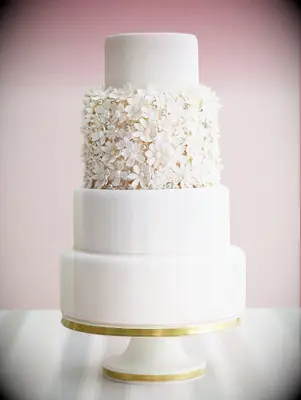 Four-tier wedding cake with texture floral accent tier