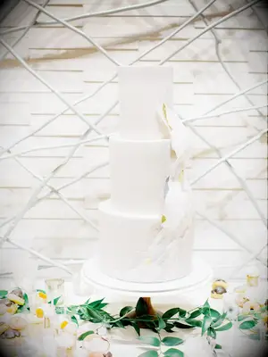 Modern white three-tier cake with wave-inspired decoration