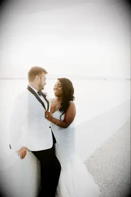 Waterfront portraits with bride and groom in white attire