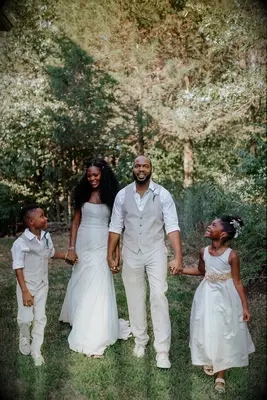 Couple with children all dressed in white outfits