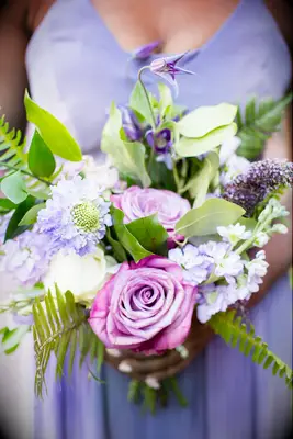 purple bridesmaid bouquet with scabiosa, roses, clematis, and sword fern leaves 