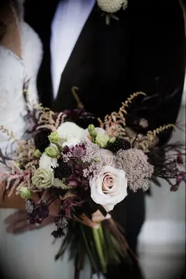dark purple wedding bouquet with burgundy scabiosa, blush roses, and light pink astilbe