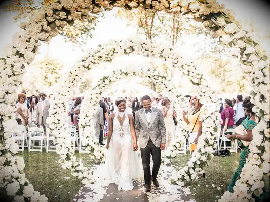 Infinity fairytale-themed wedding arch with white roses