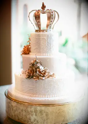 Crown cake topper on fairytale-themed wedding cake