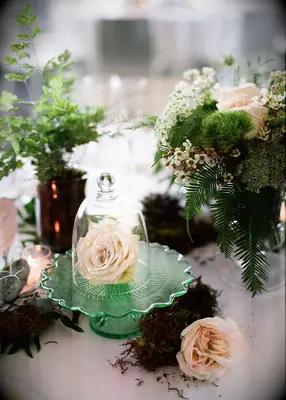 Rose terrarium centerpiece at fairytale-themed wedding
