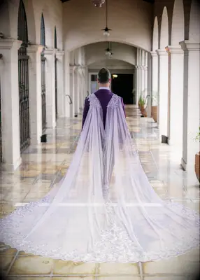 Lavender tulle cape at fairytale-inspired wedding