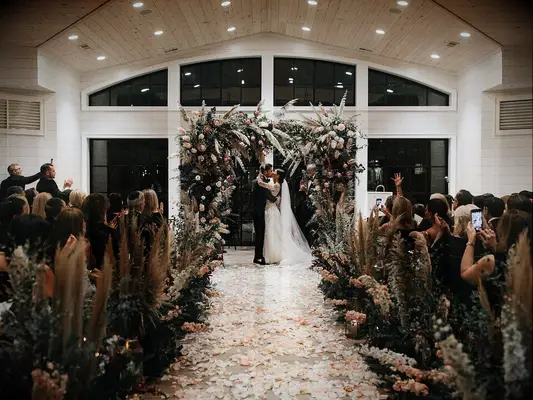 Oversized fairytale wedding arch with greenery and flowers 