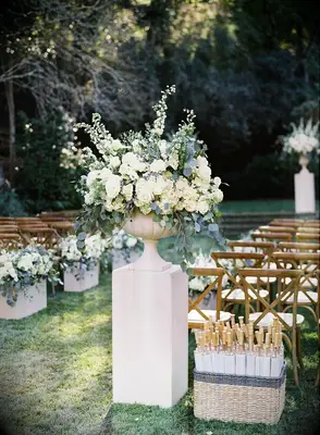A statuesque floral arrangement in cream and green.