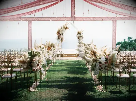 All this pampas grass lead wedding guests and the happy couple down this dreamy aisle.