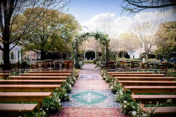 What a wedding arch! Sprays of delicate white flowers and romantic greenery frame the day.