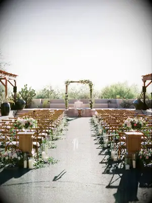 A sunny day wedding arch stands ready for the 