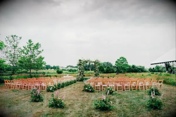 An outdoor ceremony site complete with natural-looking floral arrangements. 