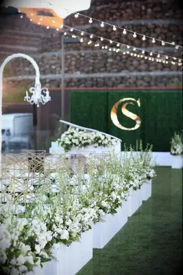 White floral arrangements wait for the happy couple to arrive.