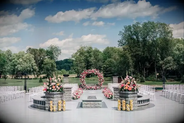 A circular floral wedding arch is ideal for a whimsical modern wedding.