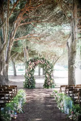 Nothing says romance like a floral archway beneath the trees.