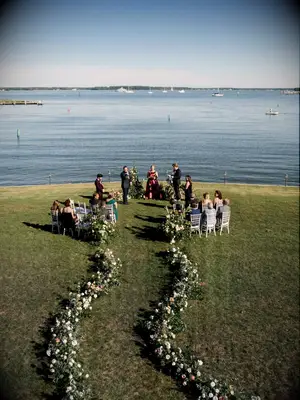 Lead guests to your ceremony with a snaking row of verdant flowers.