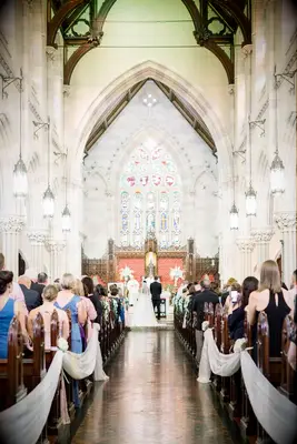 White silk bunting points guests towards the nuptials being celebrated at the altar.