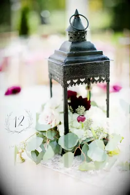 Greenery, Lanterns and Table Numbers on Dining Tables