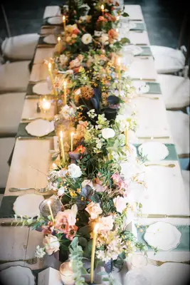 Centerpieces of Roses, Lisianthus, Ranunculus, Eucalyptus and Sweet Pea Vines