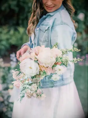 Bride Wearing Denim Jacket Holding Peony Bouquet