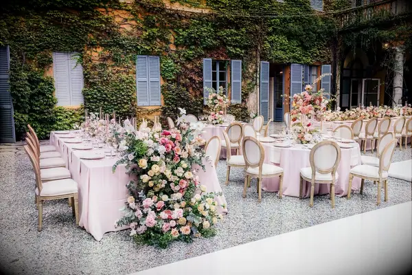 Long and Round Tables With Blush Linens, Floral Runners and Centerpieces in Historic Courtyard
