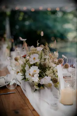 Rustic centerpiece with brown foliage and white cosmo blooms