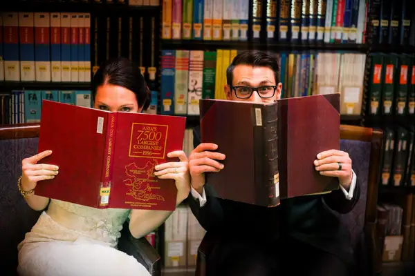 couple posing with books