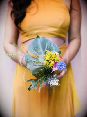 A bridesmaid holds a vibrant wildflower bouquet.