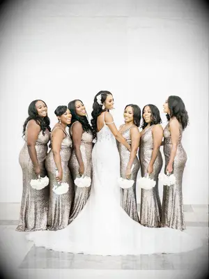 A bride and her wedding party hold gorgeous white bouquets.
