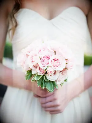 A bride holds this springtime-pink bouquet.