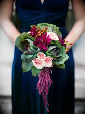 A floral cabbage and wine-toned bouquet.