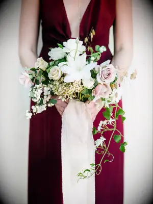 A bridesmaid holds this pale cream and pink bouquet.