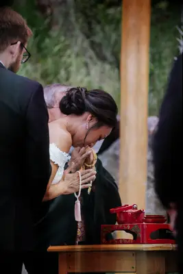 Bride bowing during Japanese sake-sharing ceremony
