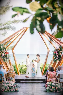 couple exchanging wedding vows during beach marriage ceremony