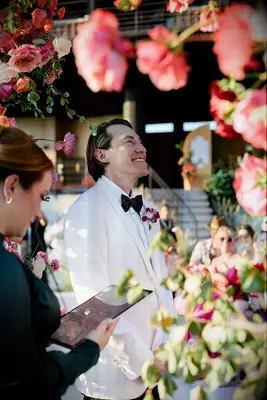 Groom smiling during wedding vows