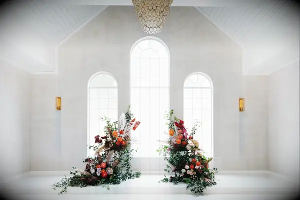 Colorful deconstructed arch in all-white chapel venue