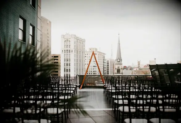 Triangle arch on terrance overlooking urban skyline