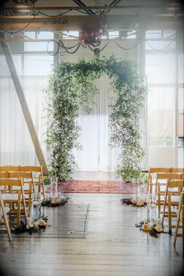 Greenery arch for loft wedding ceremony