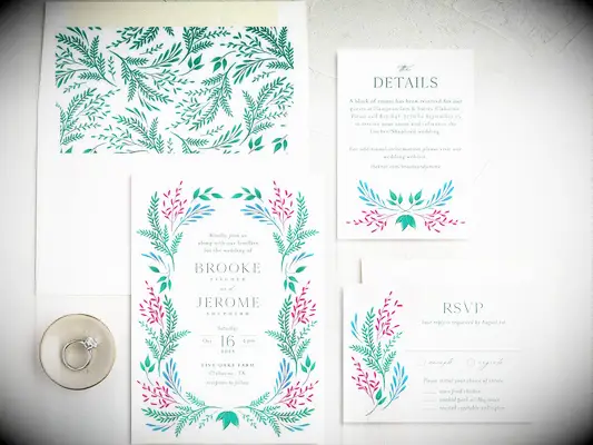 Rustic floral wedding invitation suite ready for mailing