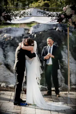 Couples sneak in hug after wedding first kiss