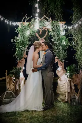 Couples first hands on waist wedding kiss pose