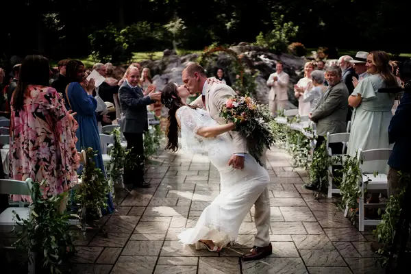 Couple Mid-Aisle Wedding Kiss
