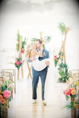 Scooped up couples first wedding kiss