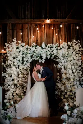 Couple doing side lean first kiss wedding pose