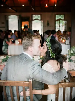 Couple kissing pose for wedding day photos