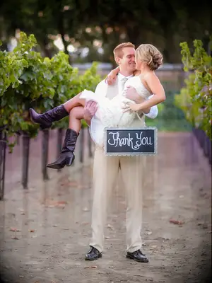 Couple wedding day pose idea with a thank-you sign