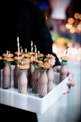 Server holding tray of Mini Milkshake Mocktails at wedding