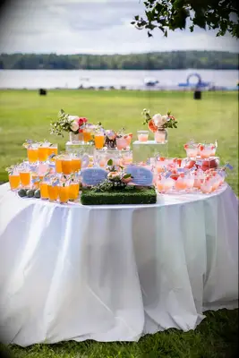 Classic mocktail display on table at outdoor wedding